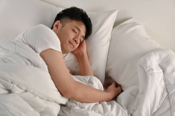 istock Handsome Young Asian man sleeping in bed 1333323180