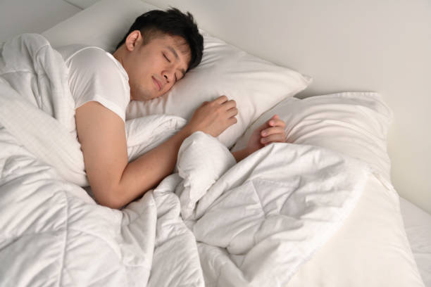istock Handsome Young Asian man sleeping in bed 1333323181