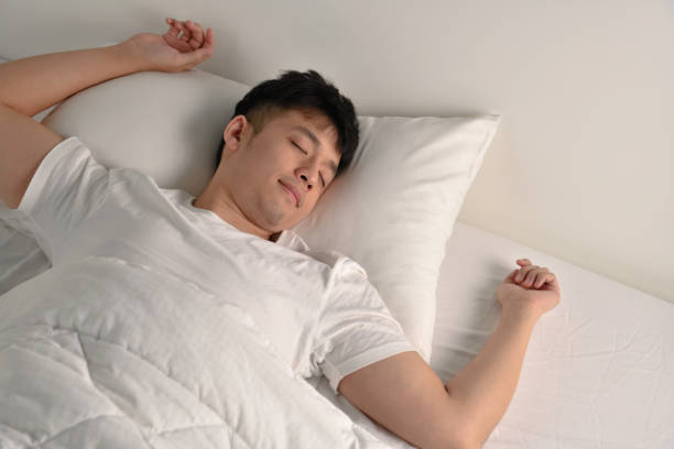 istock Handsome Young Asian man sleeping in bed 1333323185