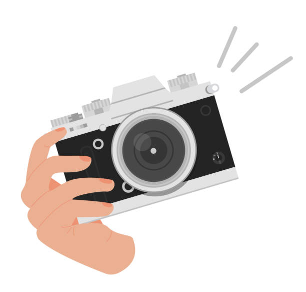 World photography day greeting card. Square banner with a hand holding digital camera in retro look. Background with world map. Vector illustration in flat cartoon style. Hand holding digital camera in retro look. Taking a picture by vintage film camera. Photographing. Isolated Vector illustration in flat cartoon style on white background. camera flash photos stock illustrations