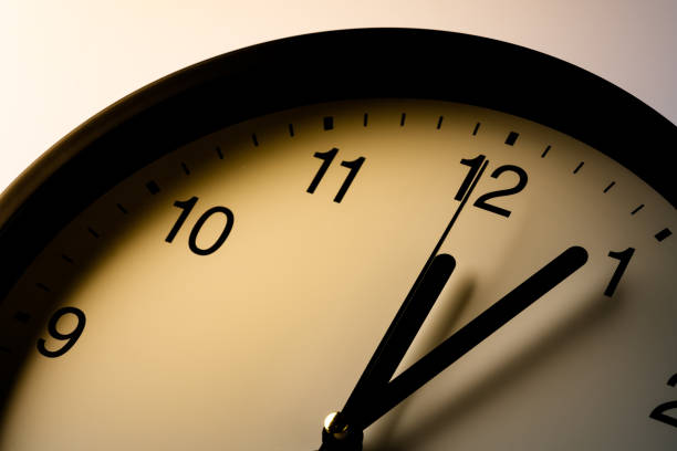 istock Clock showing the time around 12:00 1333328705
