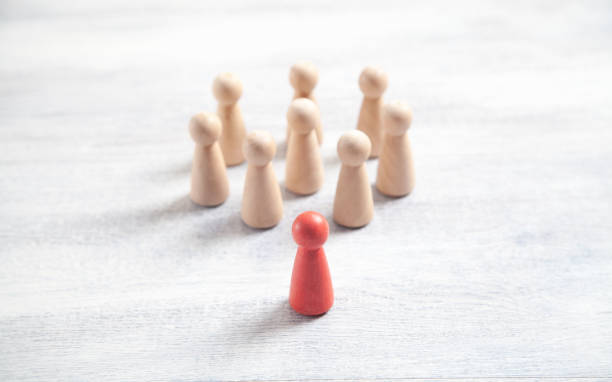 istock Wooden human figures on the white desk. Leader 1333329098