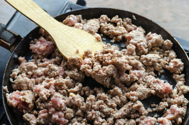 istock A man is frying minced meat in a pan. 1333335351