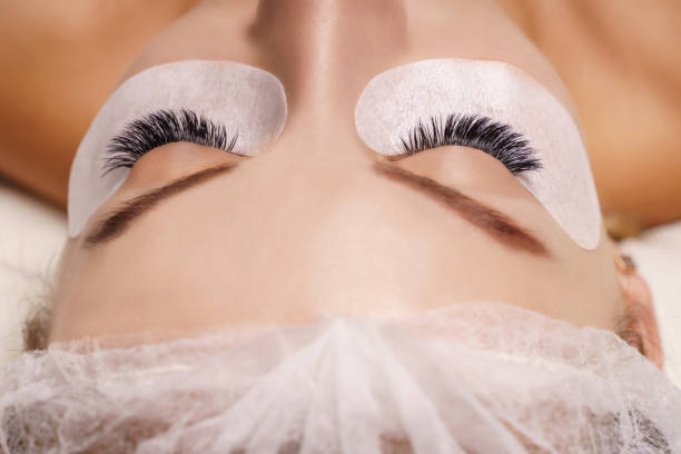 istock Eyelash Extension Procedure. Woman Eye with Long Eyelashes. Close up, selective focus 1333337444