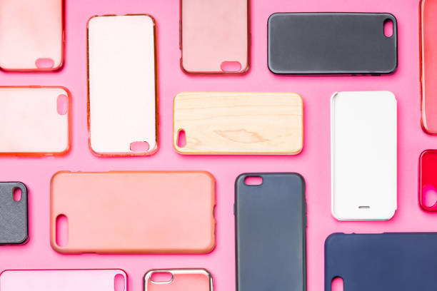 istock Pile of multicolored plastic back covers for mobile phone. Choice of smart phone protector accessories on pink background. A lot of silicone phone backs or skins next to each other 1333338785
