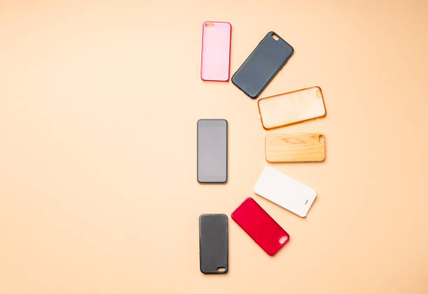 istock Choice of multicolored plastic back covers for mobile phones on neutral background with a smart phone on the side 1333338878