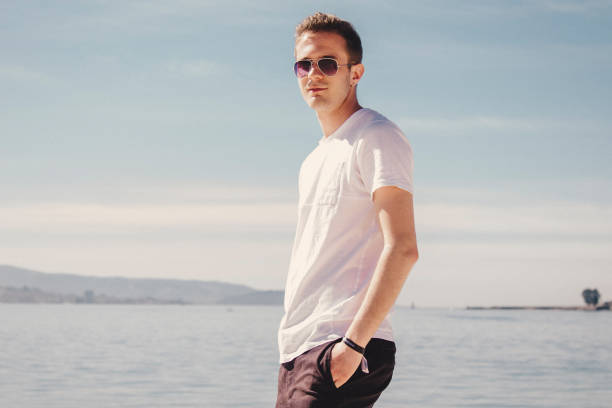istock man with sunglasses walking on the beach 1333341622