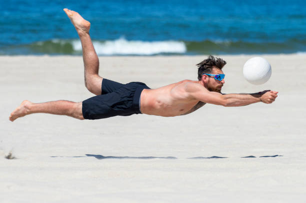 istock Shirtless Man Playing Volleyball At Beach 1333343440