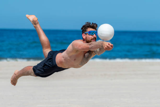 istock Shirtless Man Playing Volleyball At Beach 1333343445