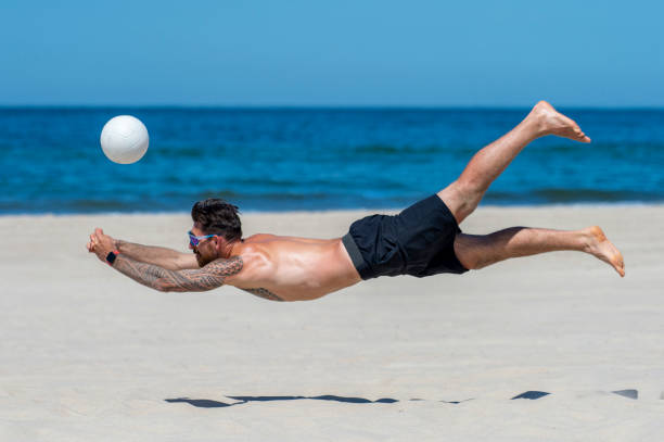 istock Shirtless Man Playing Volleyball At Beach 1333343447