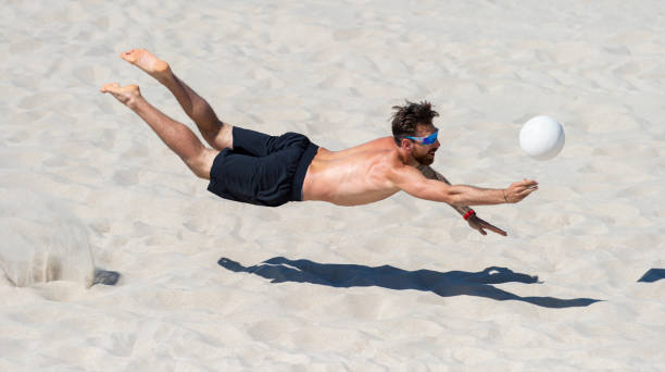 istock Shirtless Man Playing Volleyball At Beach 1333343455