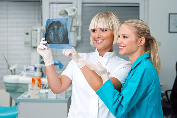 woman dentist with her assistant stock photo