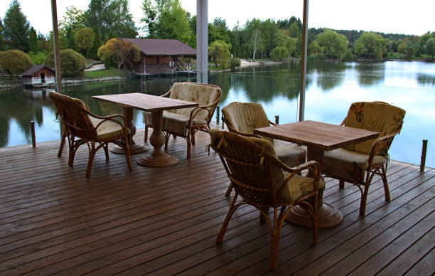 istock Open Wood Terrace With Wicker Armchairs And Tables 1333348918