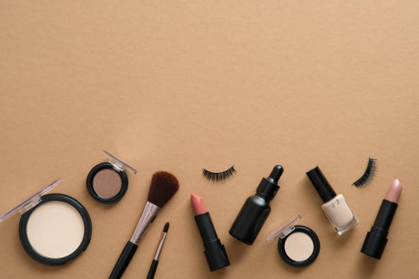istock Professional makeup tools. Make up products on brown background. Flat lay, top view. 1333348944