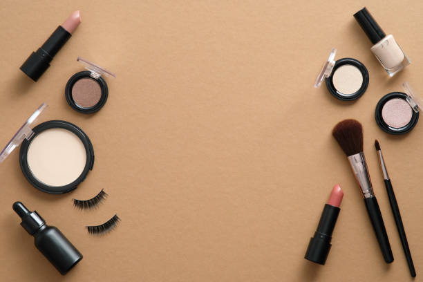istock Flat lay set of professional makeup cosmetics and tools on brown background with copy space. Beauty blog banner design. 1333348948