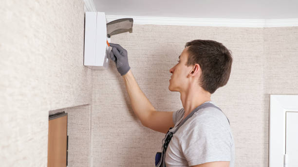 istock Electrician in uniform checks switchboard in entry room 1333349737