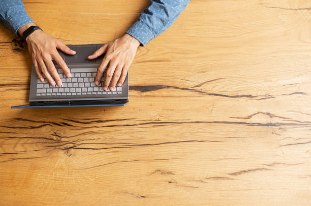 istock Male hands typing on the keyboard, top view 1333350299