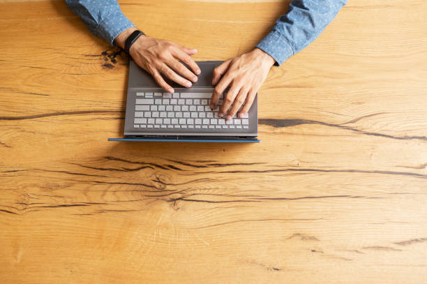 istock View from the top at businessman hands are typing and using laptop keyboard 1333350304