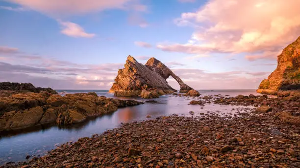 Photo of Bow Fiddle Rock at sunset in Portknockie in Scotland