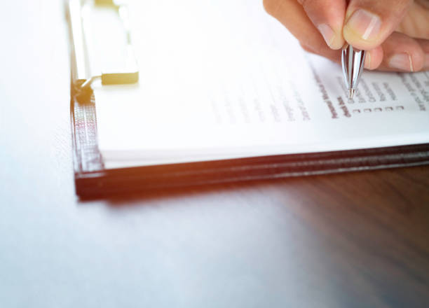 istock Close-up of Hand using writing pen with questionnaire or paperwork survey 1333354037
