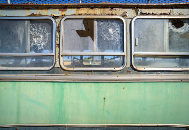 Abandoned old bus side view. Vintage pattern with peeled paint and broken glass