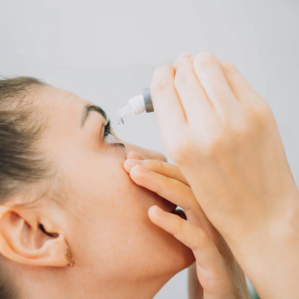 istock Young girl buries her eyes with special eye drops 1333356596