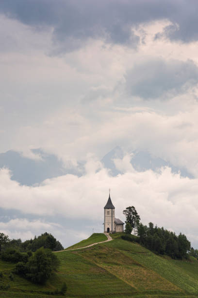 istock St Primoz Church in Jamnik Sovenia on Hill Top In Clouds 1333363324