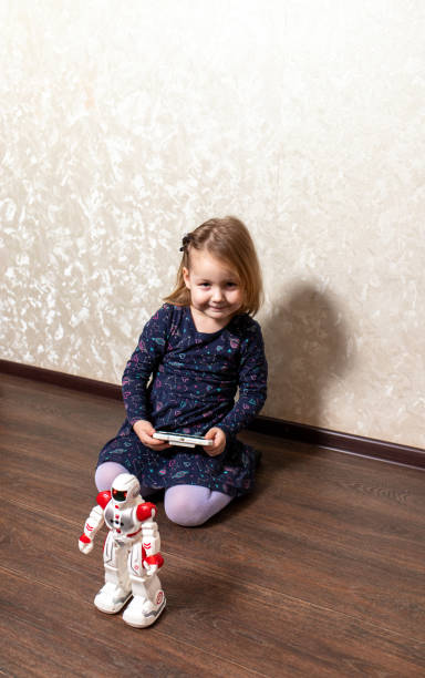 istock the child controls the robot from the remote control 1333370168