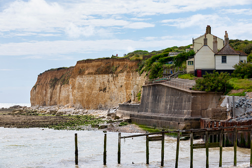 Seaford, England - August 01, 2020: Seven sisters cottages at seaside of UK, East Sussex, UK.