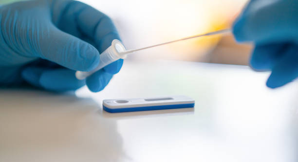 Man using a rapid antigen test kit. Rapid antigen testing is a screening tool to help to detect Corona COVID-19 in people without any symptoms of Sars-CoV-2. stock photo