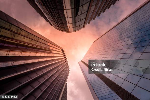 Looking Up At Skyscrapers Stock Photo - Download Image Now - Sunset, Skyscraper, Building Exterior