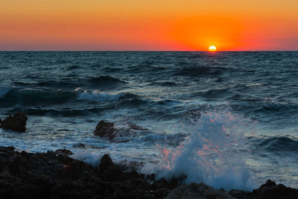 istock Sunset and storm at sea. Big waves against the setting sun. 1333375647