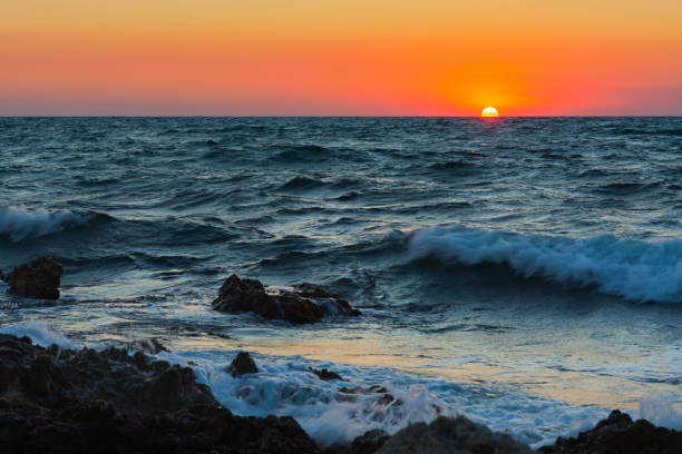 istock Sunset and storm at sea. Big waves against the setting sun. 1333375780