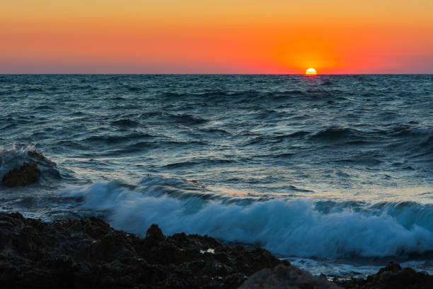 istock Sunset and storm at sea. Big waves against the setting sun. 1333375781