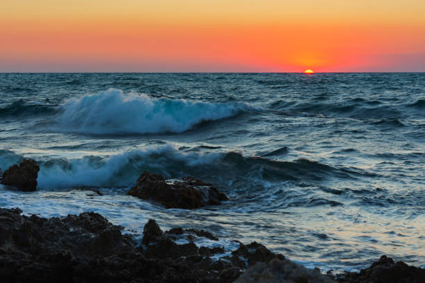 istock Sunset and storm at sea. Big waves against the setting sun. 1333375784