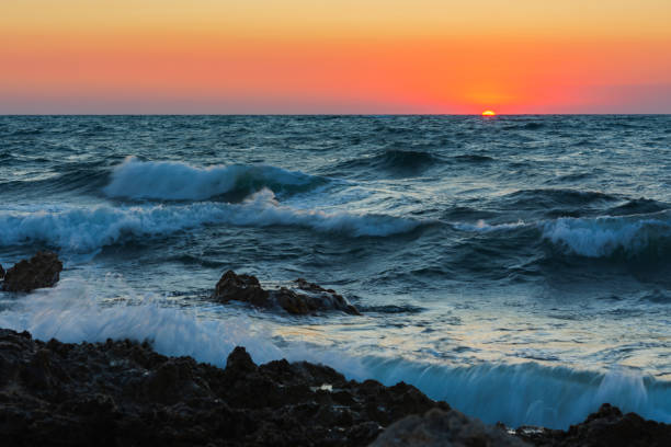 istock Sunset and storm at sea. Big waves against the setting sun. 1333375874