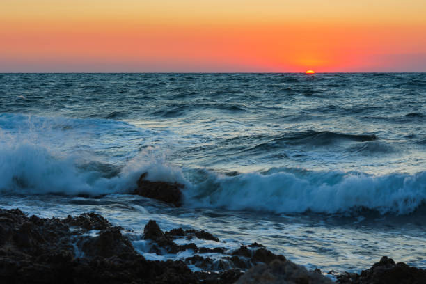 istock Sunset and storm at sea. Big waves against the setting sun. 1333375876