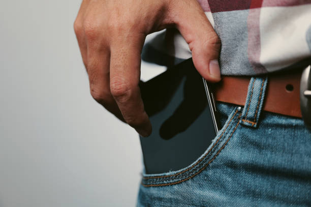 Mobile phone in denim jean pocket Mobile phone in denim jean pocket pocket stock pictures, royalty-free photos & images