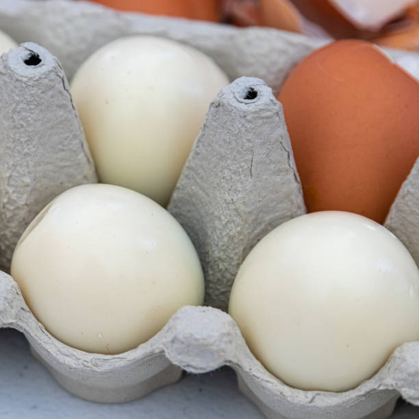 istock four hard-boiled eggs, three of which are shelled 1333378088