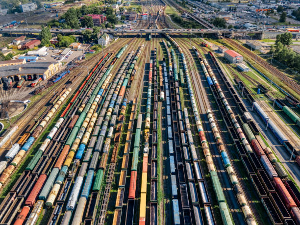 Aerial photo of lots of various wagons: tanks, platforms, dump trucks, dumpcars stay on railways at terminal. Cargo transportation of various goods by rail. Import and export logistics. shunting yard stock pictures, royalty-free photos & images