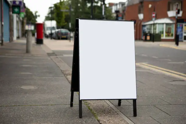 Photo of Plain white A-frame sign on a pavement in a residential area