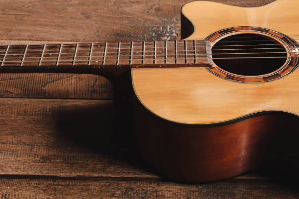 istock classical guitar on wooden background 1333383874