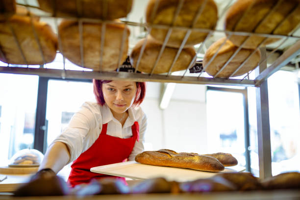 istock Beautiful young redhead female worker working in bakery. 1333383999