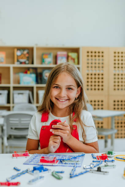istock Teenage girl constructing electrical mechanism in the classroom 1333385596