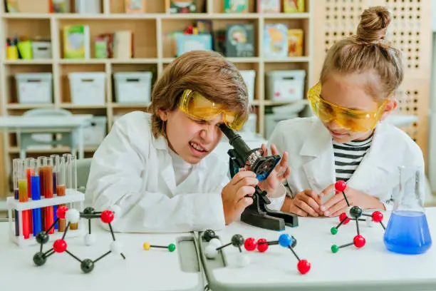 Elementary school students during a Chemistry lesson in the classroom.