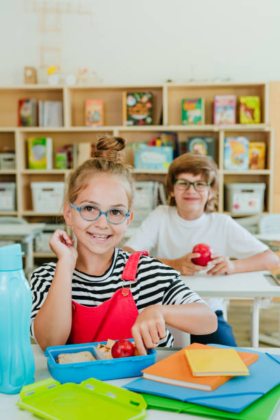 istock Elementary school students eating from the lunchboxes in the classroom 1333385947