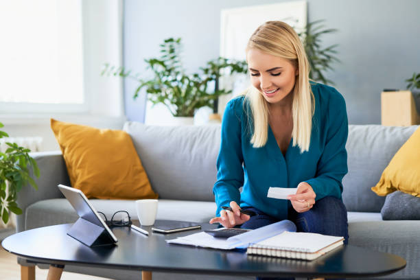 istock Successful young woman calculating home finances planning savings 1333386796