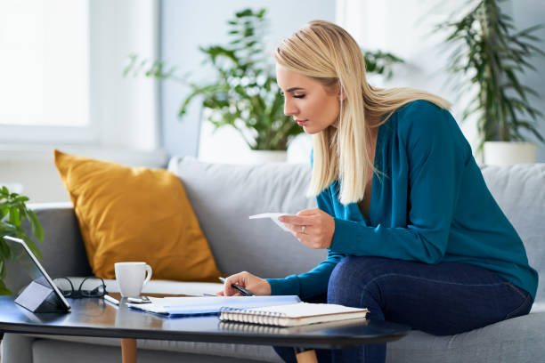 istock Young woman counting finances, doing paperwork working at home 1333386831