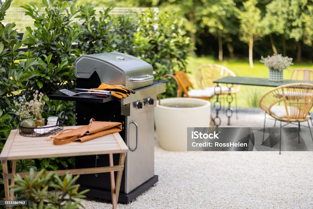 Backyard with barbeque and dining table Beautiful backyard with barbeque area and dining table Barbecue Grill Stock Photo