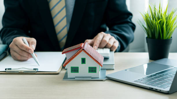istock Sales representatives work at the desk with home purchase contracts or on office loans and interest rates. 1333388016